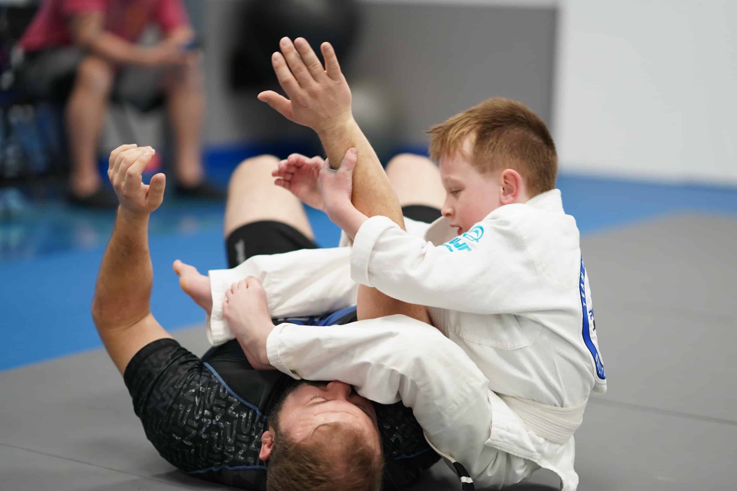 pinnacle jiu jitsu kid grappling instructor on mat