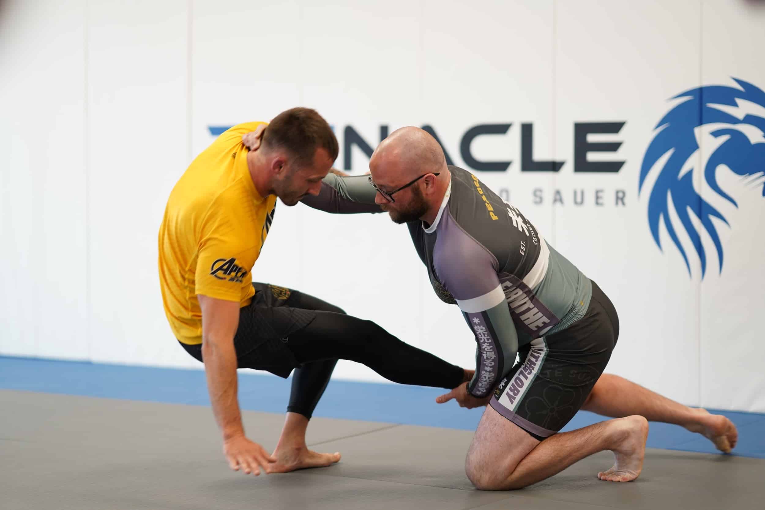 two adult students sparring during bjj class at Pinnacle Jiu Jitsu